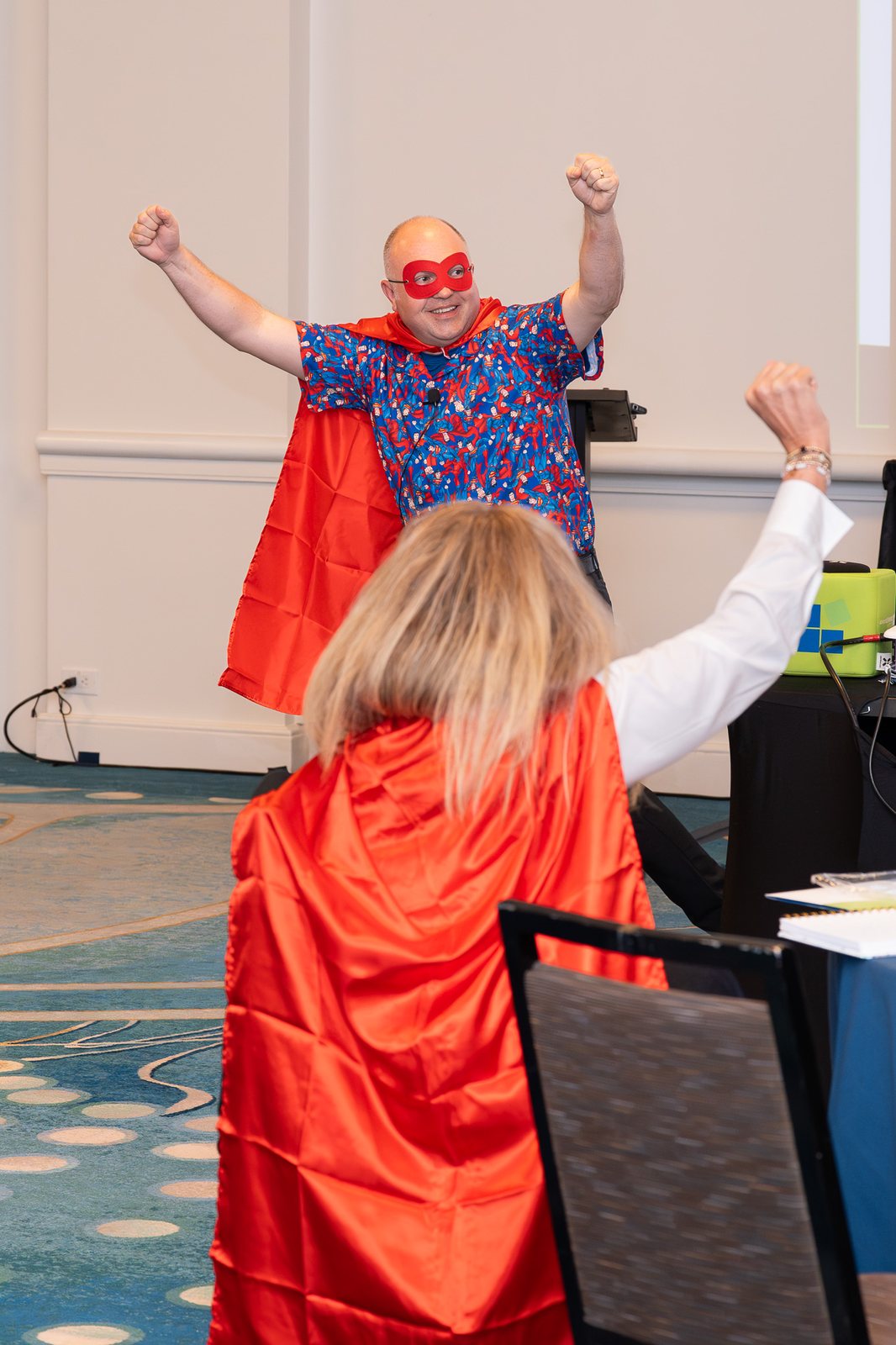 A speaker in a red cape