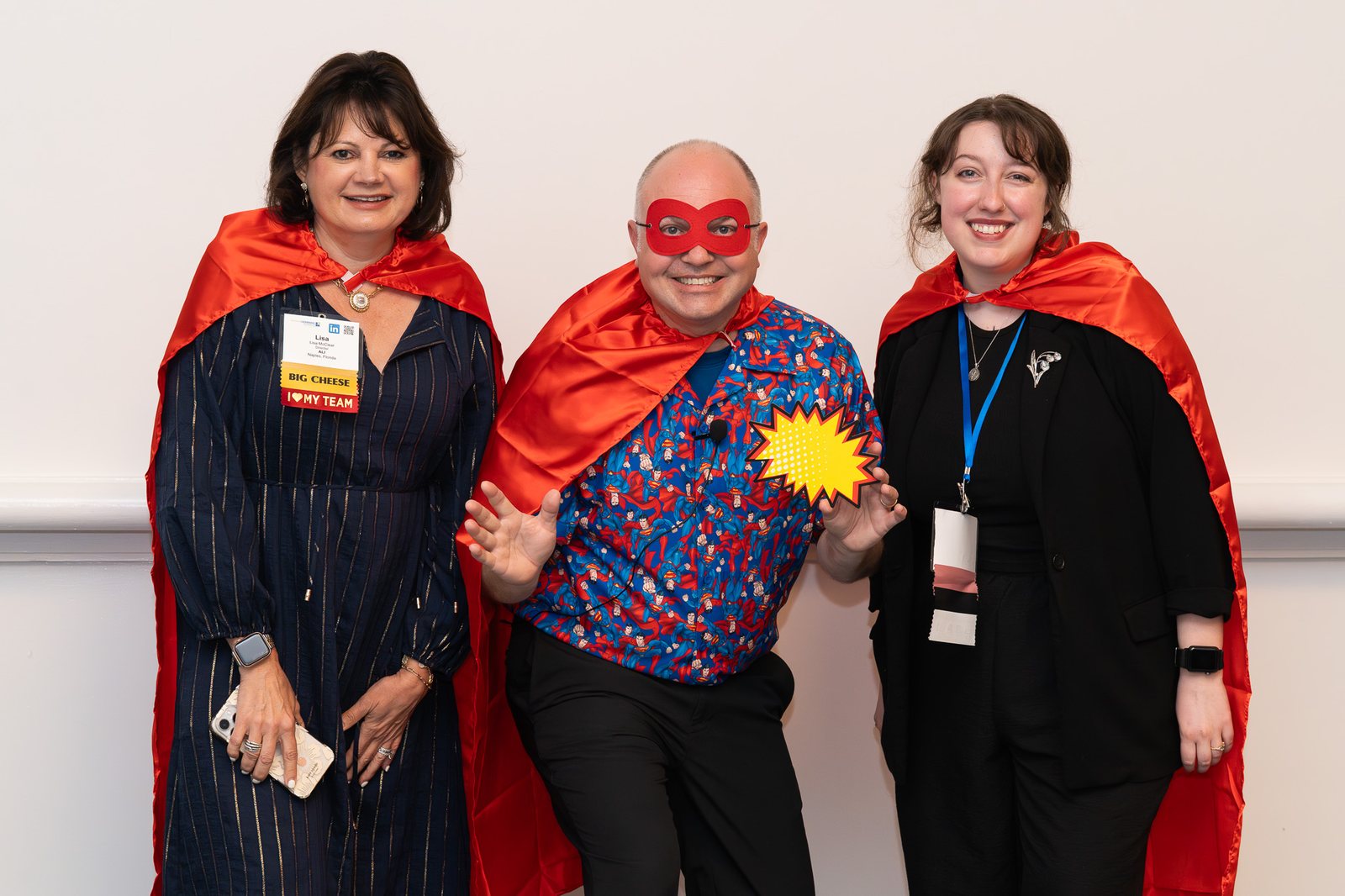 Attendees in red capes