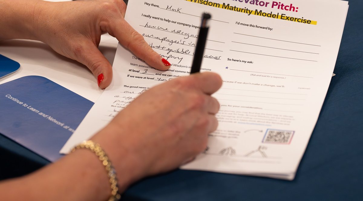 An attendee filling in the Build Your Elevator Pitch worksheet