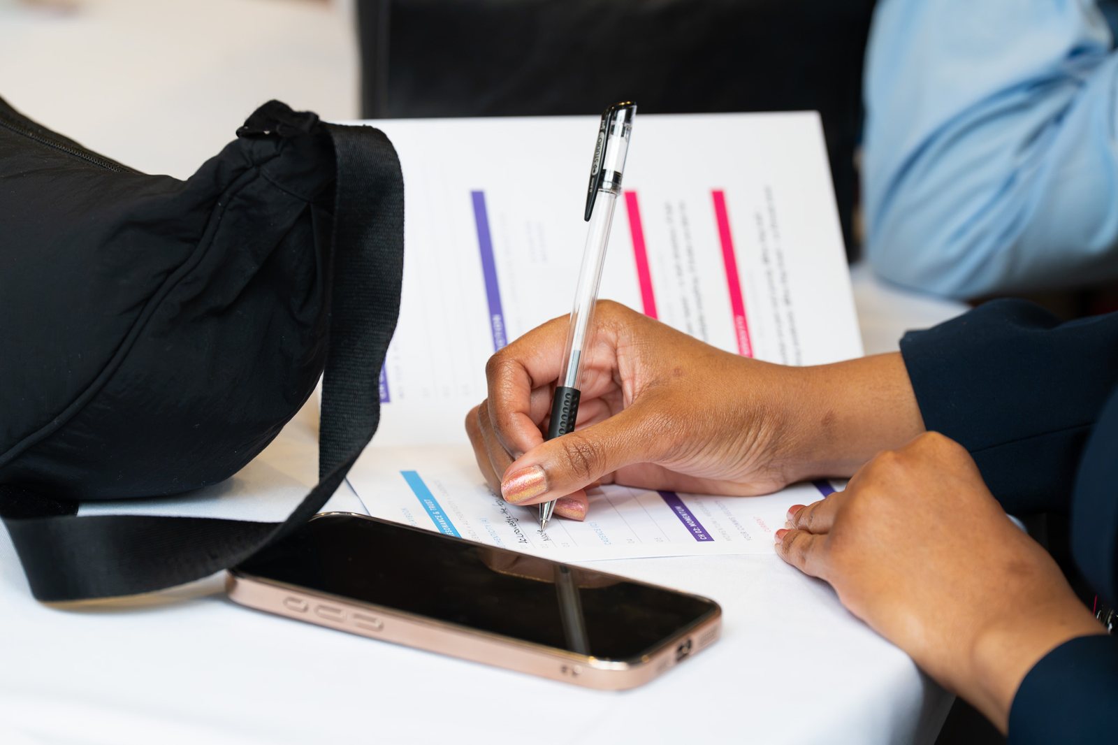 An attendee taking notes