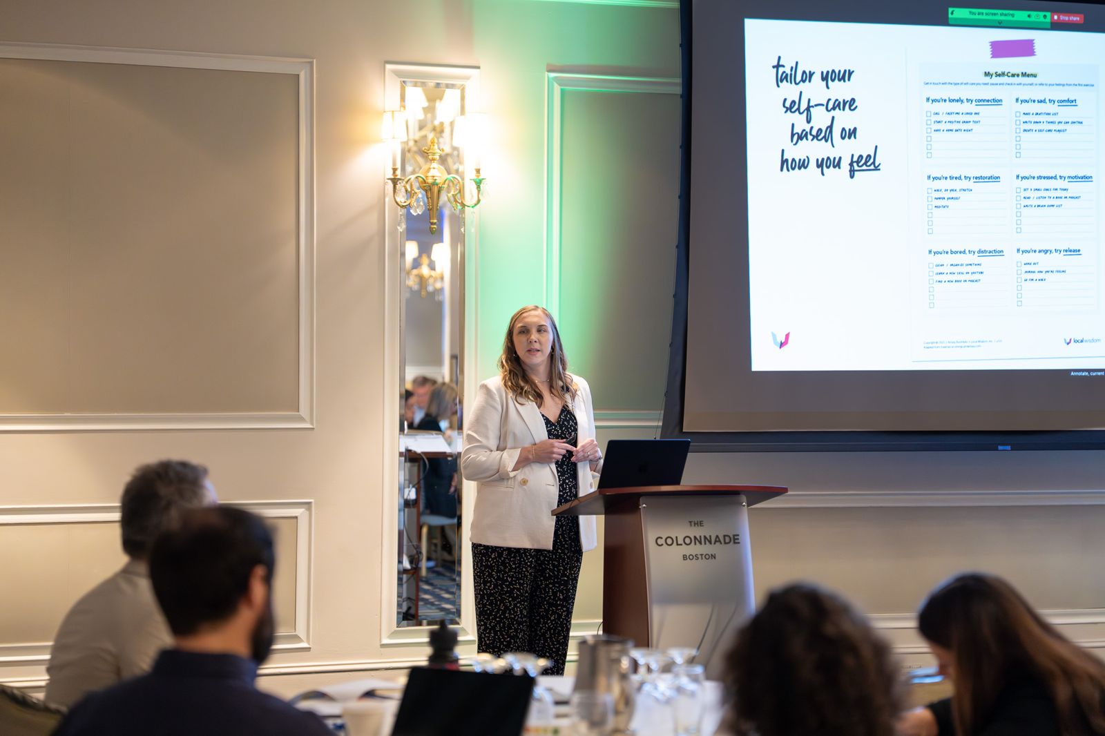 Kelsey Buckholtz beside the self-care menu slide