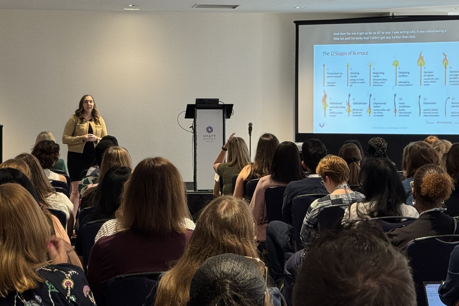 Kelsey Buckholtz presenting the 12 stages of burnout at IABC World Conference 2025