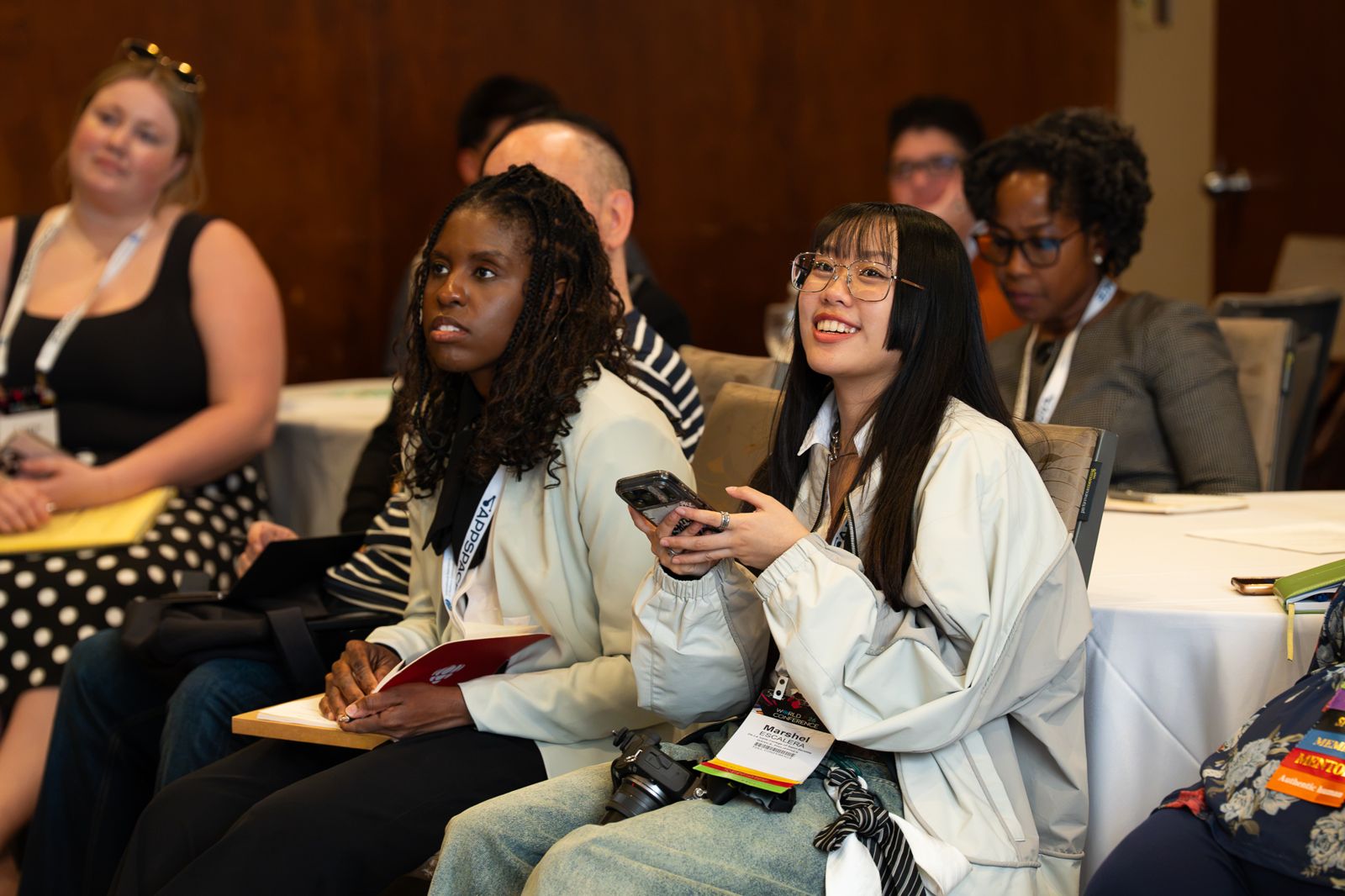 Engaged audience members at their table