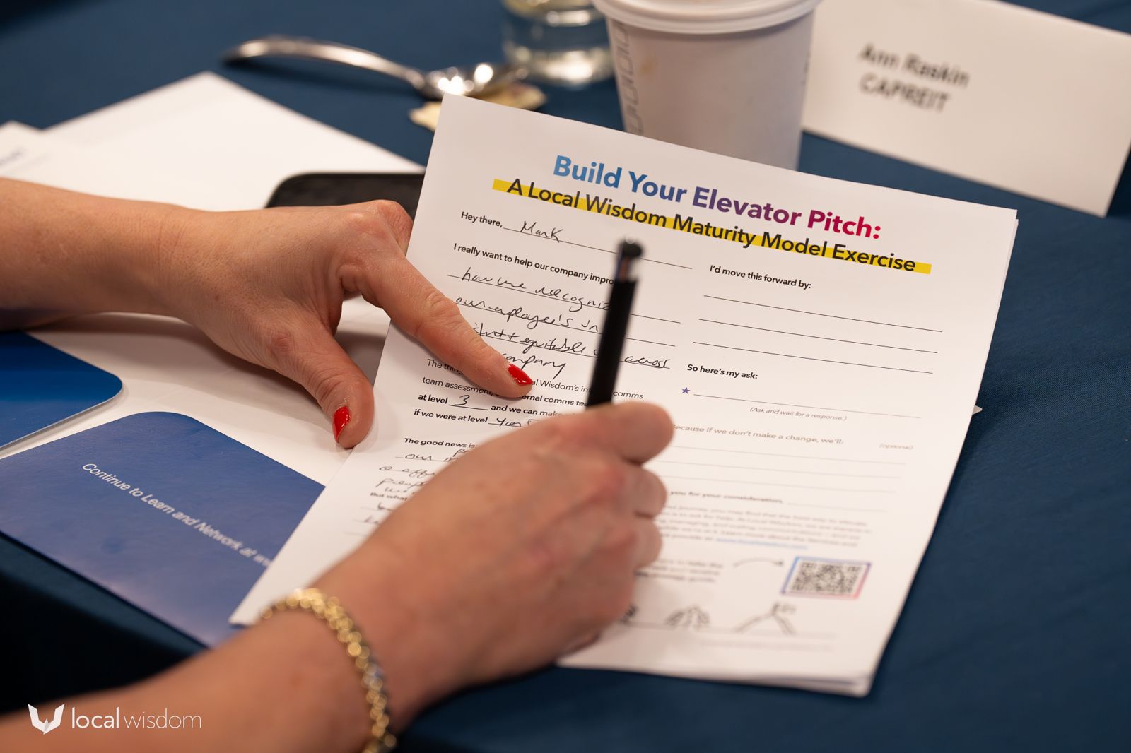 An attendee filling in the Build Your Elevator Pitch worksheet