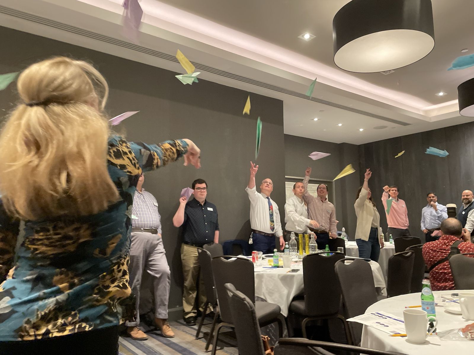 Paper airplanes in mid-air during the session