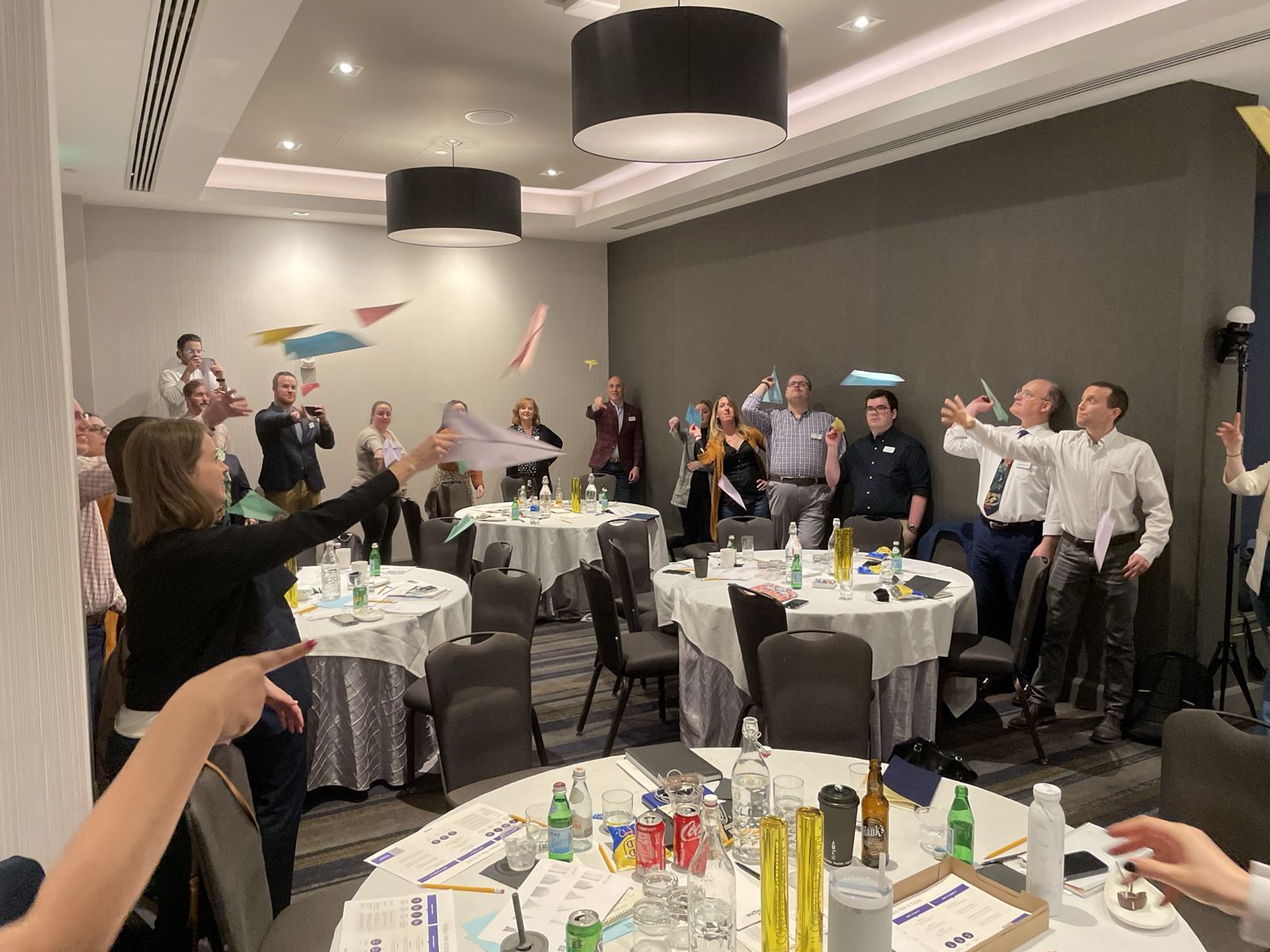 The whole room on its feet, throwing paper airplanes