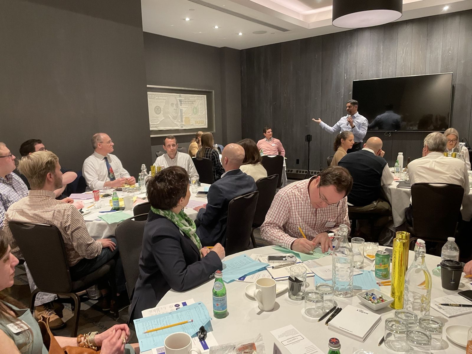 Attendees at their tables working through the exercises