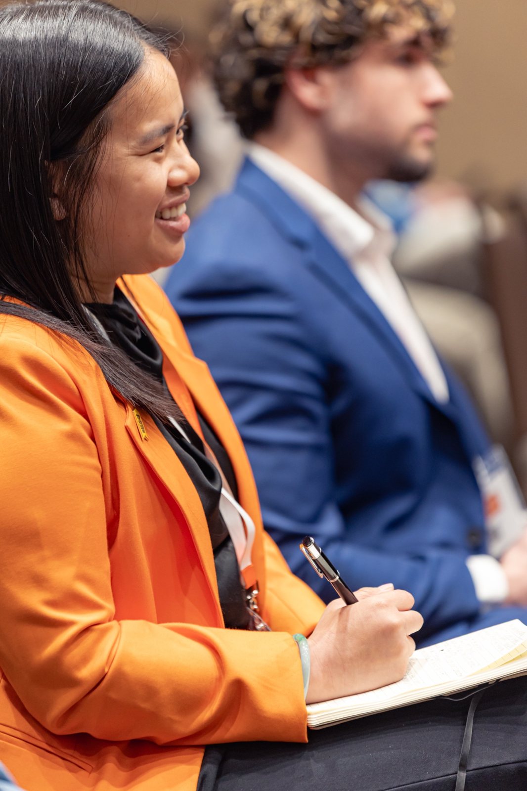 An attendee taking notes during the session