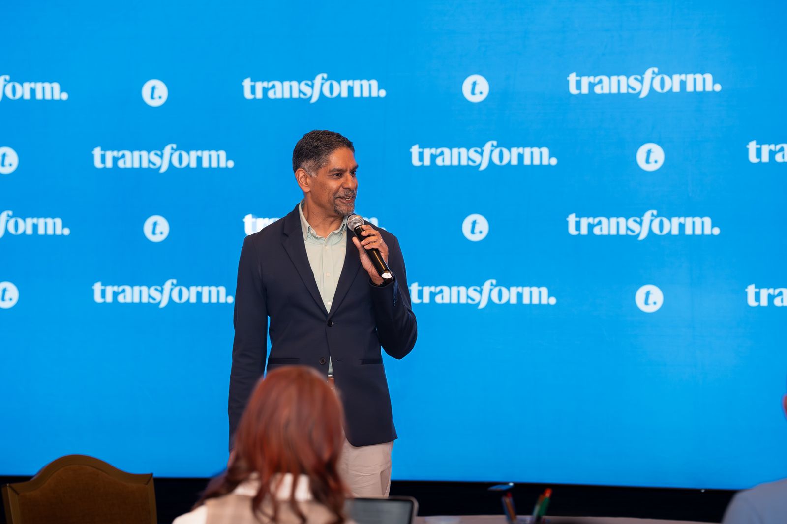 Pinaki Kathiari speaking in front of the Transform backdrop