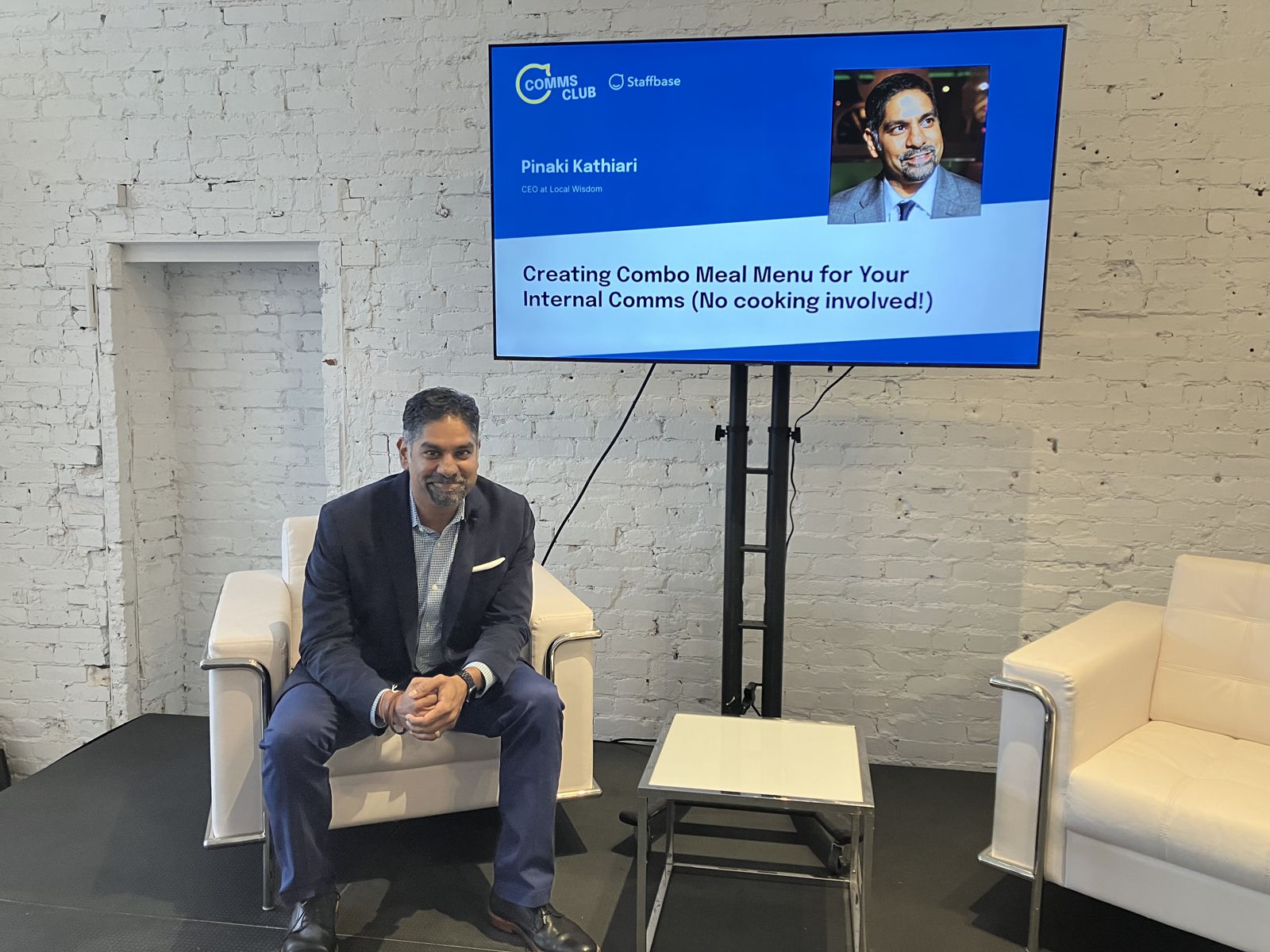 Pinaki Kathiari beside his title slide at Staffbase Comms Club 2022